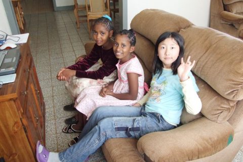 Ye Lim sits with two young girls during her year-long stay in Ethiopia with her family. | Courtesy Ye Lim Kim