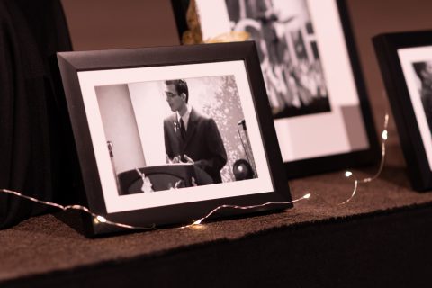 Photos from GYC history lined the stage at the convention in 2022. Pictured here, Israel Ramos, then president of GYC speaks at a previous convention. [Photo: Samuel Girven]