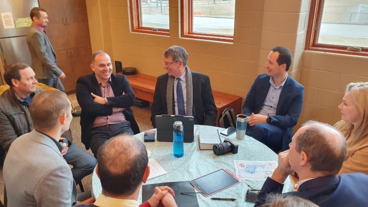 Illinois Conference President John Grys (center) meets with Pastor Russ Drumi (right), Vitalii Hanulich (second from left), and other members of the Ukrainian Seventh-day Adventist Church.