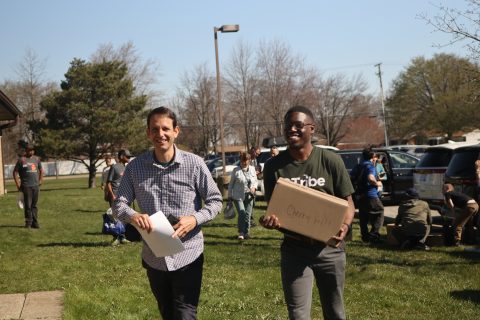 Giancarlo de Miranda, lead pastor of the Warren church (left), and Jorge Neketela, pastor of the Farmington and Cherry Hill churches (right), assist with loading the vans with boxes of books on Thursday morning of the Streams of Light International Michigan Mission Trip. [Arisha Arvat]