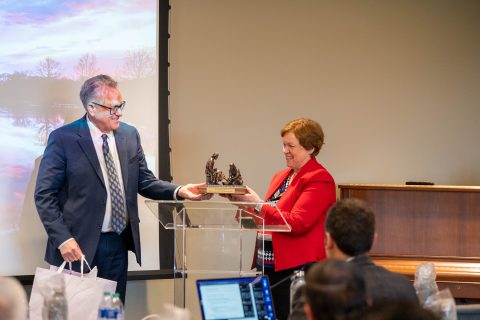 Lake Union President Ken Denslow presents Andrews University President Dr. Andrea Luxton with a bronze sculpture of Jesus washing the feet of a disciple. Luxton is departing the university, and by extension the executive committee. [Katie Fellows]