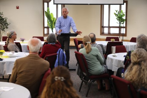 “Pastor Ron Kelly encourages guests at the celebration dinner.” [Robert Rice]