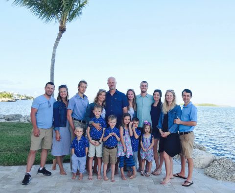 The DeWind family in 2019. From left to right: Jonathan and Devon Fenner; Wesley DeWind; Kim and Jeff DeWind; Emily DeWind; Nate and Christina DeWind; Megan and Ilko Tchakarov. Nora is on the front right, in front of Nate. [Source: Devon Fenner]