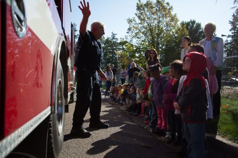 Children from The Crayon Box listen to a fire safety presentation.