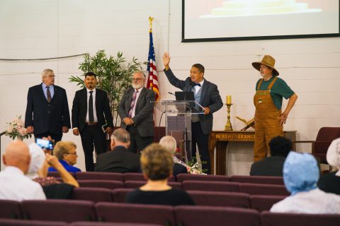Reflecting on the church’s enduring legacy, current pastor Ian Santos (at lectern) encouraged the congregation to embrace their heritage and build upon it.