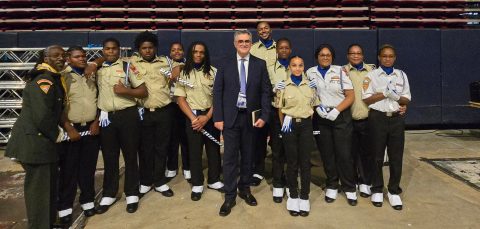 Members of the Motor City Drum Corps along with Lake Region Executive Pathfinder Coordinator Ruphos Brown flank General Conference President Erton Köhler.