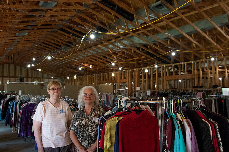 Gerrie Wright, left, and Linda Tuthill pose for a photo at The Open Door, which gives free clothes and other items to people in need. 
