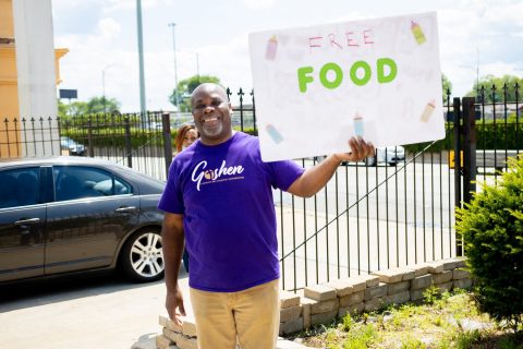 Goshen Pastor Gordon Fraser promotes the food giveaway.
