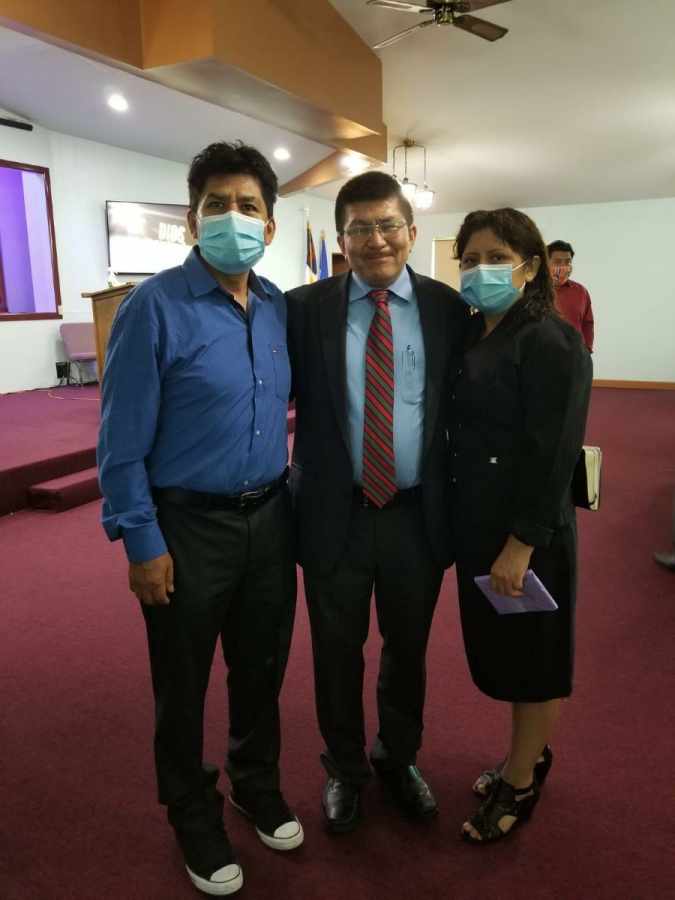 Rufina Medina and Juan Martinez pose with Pastor Bahena after their baptism.