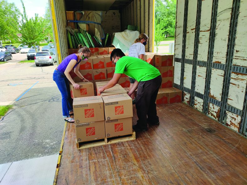 CAR staff unload boxes onto a pallet