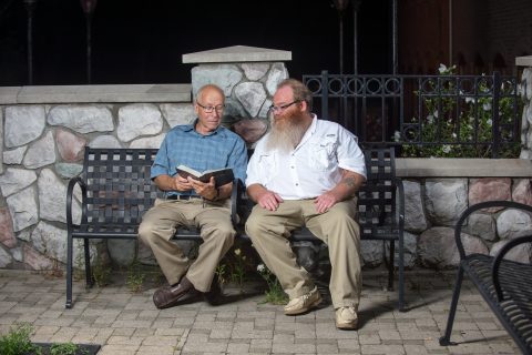Rod Dunneback (left), a 75-year-old General Motors retiree, visited Gilbert Poole and other inmates. “These men have hit rock bottom and are searching,” says Rod. “They are helpless and it’s just so rewarding that you can turn on the light of Jesus for them.” Photo Credit: Jason Lounds