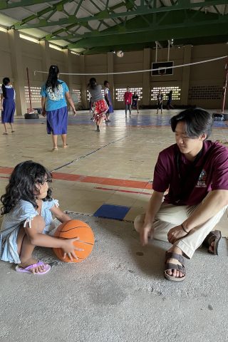 Garett Lee with a student in Majuro. Photo courtesy of Garett Lee