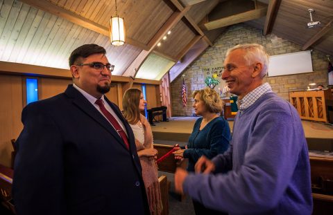 Church members Krzysztof Borowski and his wife Mirka Borowski welcome the pastoral couple following the installation service last fall. |  Photo credit: Andrzej Mucka